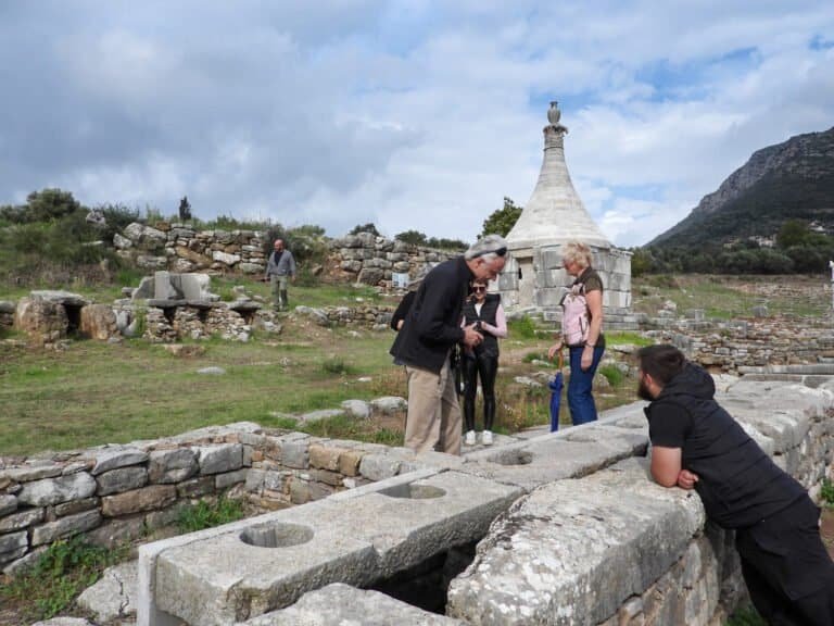 Exploring ancient ruins at Odyssey Academy, a historical site with visitors learning about its rich.