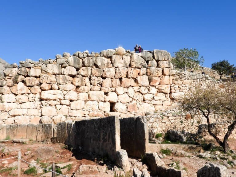 Ancient stone ruins at Odyssey Academy archaeological site in Greece.