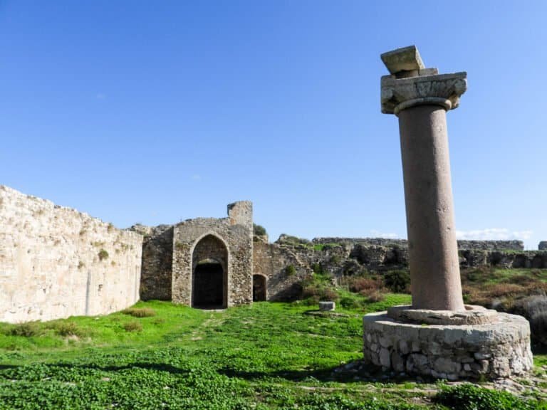 Ancient ruins and stone columns at Odyssey Academy archaeological site.