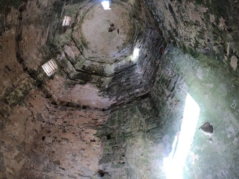 Ancient stone well with sunlight entering from the top, showcasing historic architecture and natural.