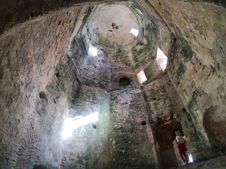 Underground archaeological site with stone walls and small windows at Odyssey Academy.