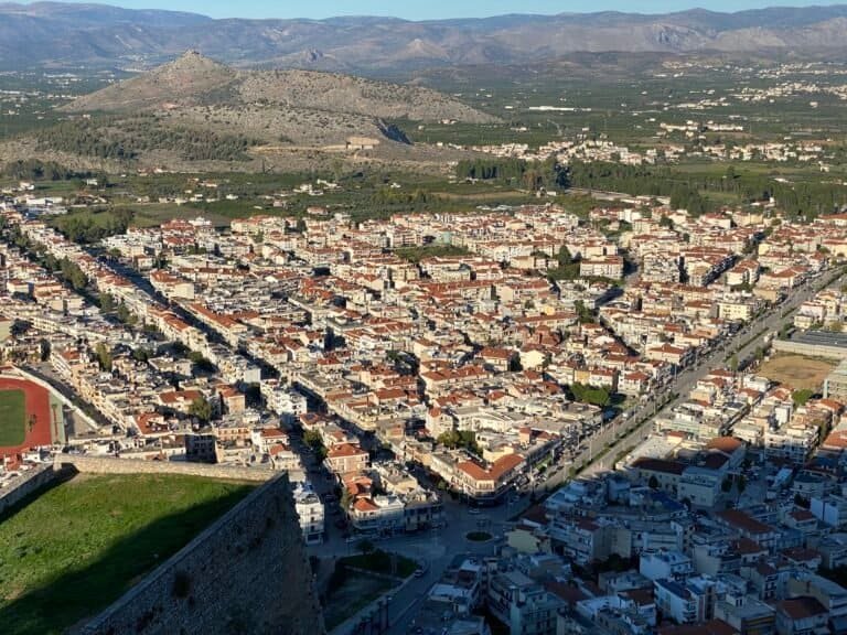 Aerial view of Odyssey Academy in a scenic city surrounded by mountains.