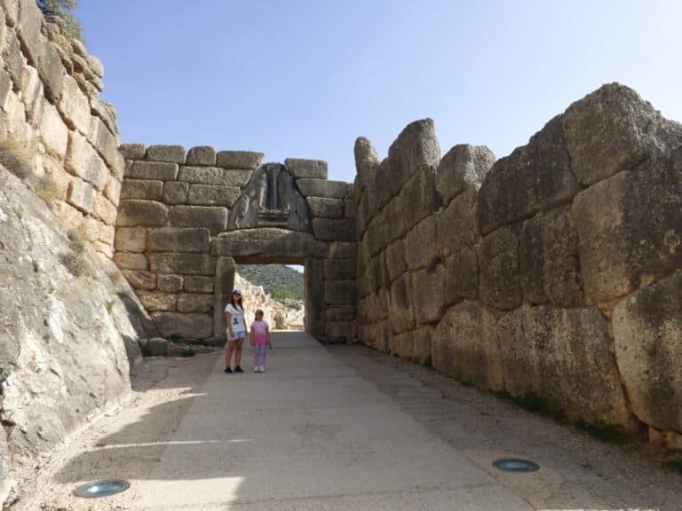 Ancient stone gateway with large rocks and archway at Odyssey Academy archaeological site.