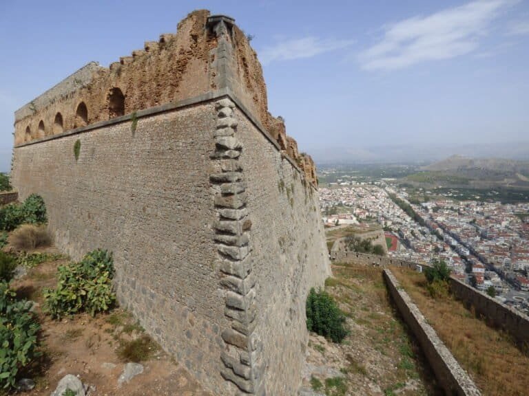 Ancient fortress ruins overlooking the cityscape of Odyssey.