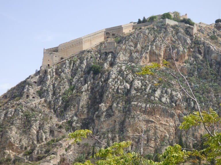 Historic fortress on rocky hilltop in Greece, part of Odyssey Academy site.