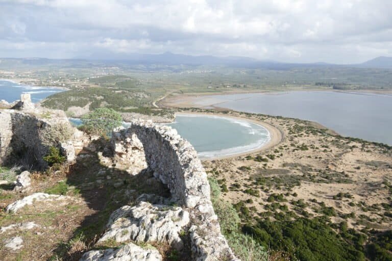 Scenic coastal landscape with ancient ruins overlooking the sea.
