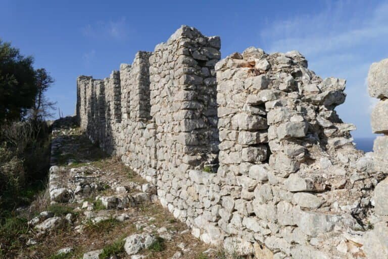 Ruins of ancient stone walls at Odyssey Academy site, historical archaeological site.