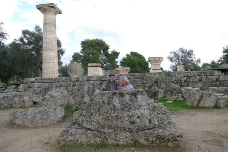 Visitors exploring ancient Greek ruins at Odyssey Academy site.