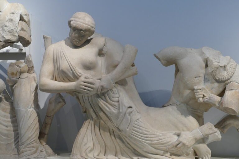 Ancient Greek marble sculpture depicting a woman and a man in classical attire.
