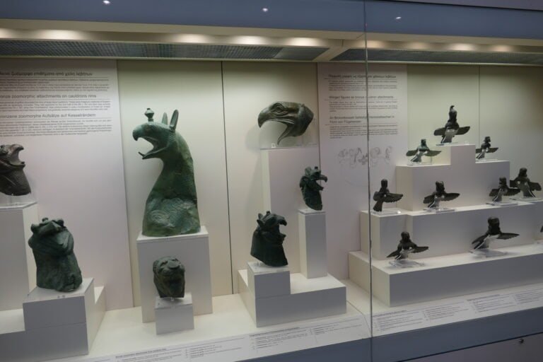 Bronze artifacts and sculptures showcased in a museum exhibit.