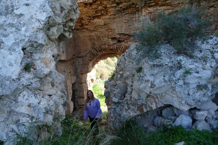 Student exploring ancient ruins at Odyssey Academy outdoor site.